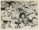 Image of Tah-tar-rah sitting among the rocks
